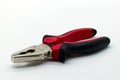Metal hand pliers with red and black rubber handless isolated on white background