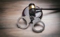 Metal handcuffs and judge gavel on the wooden background Royalty Free Stock Photo