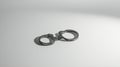 Metal handcuffs resting on a simple white background, creating a soft shadow Royalty Free Stock Photo