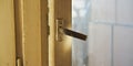 Metal handle of outdated wooden balcony door closeup