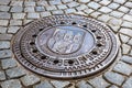 Metal hatch sewer manhole and cobblestone pavement Royalty Free Stock Photo