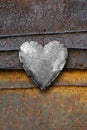 Metal heart on rusty background