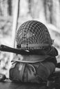 Metal Helmet Of United States Army Infantry Soldier At World War II. Helmet On Camping Tent In Forest Camp. black and Royalty Free Stock Photo