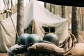 Metal Helmets Of United States Army Infantry Soldier At World War II. Helmets Near Camping Tent In Forest Camp Royalty Free Stock Photo