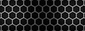 Metal honeycomb grid on a black background