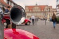 metal horn on red car fender on background of city streets Royalty Free Stock Photo