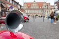 metal horn on red car fender on background of city streets Royalty Free Stock Photo