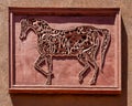 Metal horse relief on a courtyard wall in the Kasbah Tamadot, Sir Richard Branson`s Moroccan Retreat.