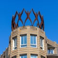 Metal human sculpture on roof top of a historic building in old city Centre of Hague, Netherlands