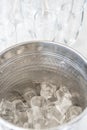 A metal ice bucket with full of crushed ice and stainless scoop for dessert on table in hotel. Royalty Free Stock Photo