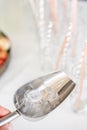 A metal ice bucket with full of crushed ice and stainless scoop for dessert on table in hotel. Royalty Free Stock Photo