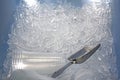 Metal ice scoop and plastic cup on the ice in bucket Royalty Free Stock Photo