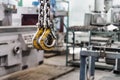 Metal industrial chains with hooks in the workshop of a metallurgical plant. Close-up. Lifting hooks for lifting heavy materials Royalty Free Stock Photo