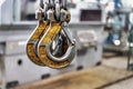 Metal industrial chains with hooks in the workshop of a metallurgical plant. Close-up. Lifting hooks for lifting heavy materials Royalty Free Stock Photo