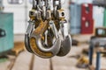 Metal industrial chains with hooks in the workshop of a metallurgical plant. Close-up. Lifting hooks for lifting heavy materials Royalty Free Stock Photo