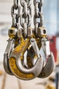 Metal industrial chains with hooks in the workshop of a metallurgical plant. Close-up. Lifting hooks for lifting heavy materials Royalty Free Stock Photo