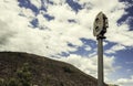 Metal instrument attached to a pole next to the mountain under the sky full of clouds Royalty Free Stock Photo