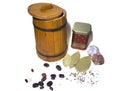Metal jar with the word `loorber` and a wooden barrel with beans, garlic, caraway seeds, coriander, bay leaf on a white backgroun