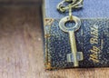 The metal key on holy bible on wooden table Royalty Free Stock Photo