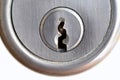 Metal key plate with keyhole of a cylinder lock in a door Royalty Free Stock Photo