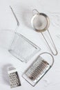 Metal kitchen accessories. kitchen utensils grater, strainer and basket Royalty Free Stock Photo