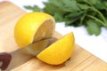 Metal knife cuts lemon