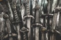 Metal knight swords background. The concept Knights. Royalty Free Stock Photo