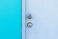 Metal knob on entrance to the old door house white with wall blue. Royalty Free Stock Photo