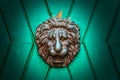 The Metal knocker like a lion`s head in a green doorway Royalty Free Stock Photo
