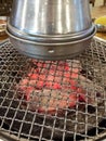 Metal Korean barbecue with red hot coals and chimney above Royalty Free Stock Photo