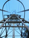 Metal ladde with blue white paint on galvanized surface, rusty places. Broken safety frame around main beams. Royalty Free Stock Photo