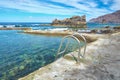 Metal ladder leading into a clear sea water pool at the Atlantic coast. Royalty Free Stock Photo