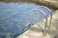 Metal ladder leading into a clear seawater pool on La Maceta Royalty Free Stock Photo