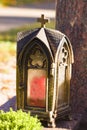 Metal lamp box with the crucifiction on the door. Memorial found in a cemetery in Germany. Keep the lamp burning