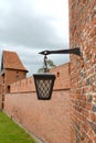 Metal lantern on the background of the fortress wall. Cathedral complex. Frombork, Poland