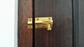 A metal latch door lock on wooden door Royalty Free Stock Photo
