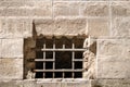 Metal lattice on a background of stone wall Royalty Free Stock Photo