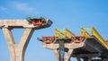 Metal launching gantry on foundation of elevated expressway structure against blue sky background, Perspective side view Royalty Free Stock Photo