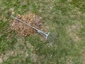 Metal lawn rake for removing dry leaves and litter from the grass