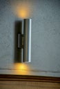 Metal light beam with orange emitting from top and bottom on interior wall for decorative purposes Royalty Free Stock Photo