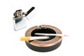 Metal lighter and two cigarettes in ashtray Royalty Free Stock Photo