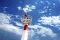 Metal lighthouse under cloudscape sky. Royalty Free Stock Photo