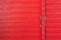 Metal lock and door handle on the red wooden door. Abstract red wood planks background wall texture. Wooden texture red colour for Royalty Free Stock Photo