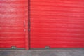 Metal lock and door handle on the red wooden door. Abstract red wood planks background wall texture. Wooden texture red colour for Royalty Free Stock Photo