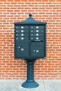 Metal mailbox against brick wall