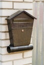 A metal mailbox on a brick wall hangs Royalty Free Stock Photo
