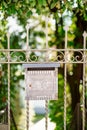 Metal mailbox with butterfly pattern on the gate.