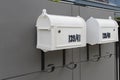 Metal mailbox and modern concrete dark grey wall for background.