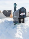 USPS metal mailbox buried in snow drift I voted sticker for vote by mail Royalty Free Stock Photo