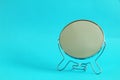 Metal make up mirror, blue background, free copy space, selective focus Royalty Free Stock Photo